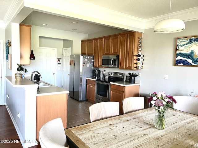 11110 Castlemain Cir S, Jacksonville, FL 32256 - kitchen featuring stainless steel appliances, brown cabinets, light countertops, crown molding, and a peninsula