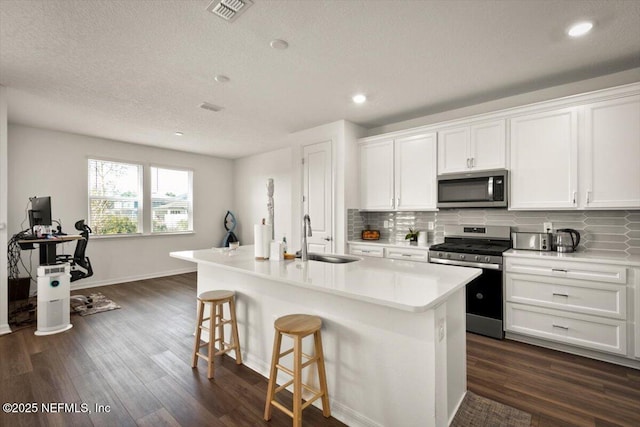 54 Torres Trce, Saint Augustine, FL 32095 - kitchen featuring appliances with stainless steel finishes, dark wood-type flooring, decorative backsplash, recessed lighting, and a textured ceiling