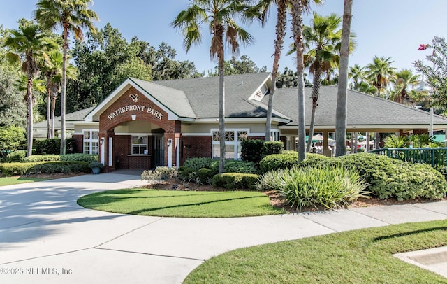 1804 Eagle Crest Dr, Fleming Island, FL 32003 - view of front facade featuring brick siding, a front lawn, and driveway