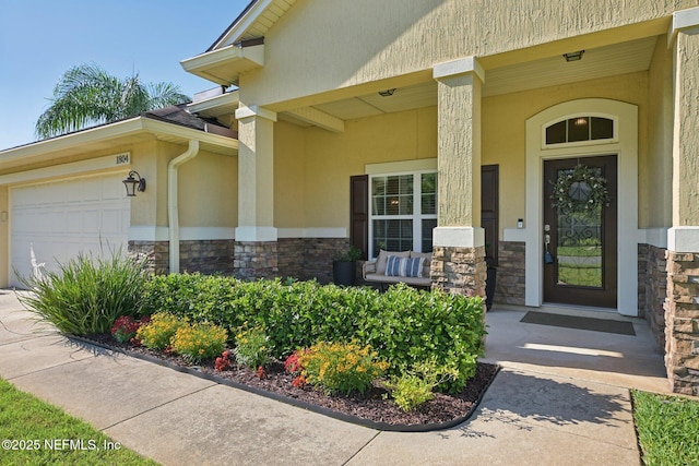1804 Eagle Crest Dr, Fleming Island, FL 32003 - doorway to property featuring stone siding, a porch, an attached garage, and stucco siding
