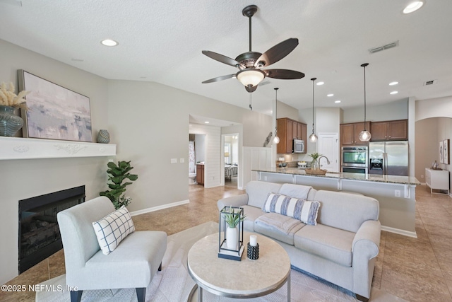 1804 Eagle Crest Dr, Fleming Island, FL 32003 - living room featuring ceiling fan, recessed lighting, light tile patterned floors, a fireplace, and vaulted ceiling
