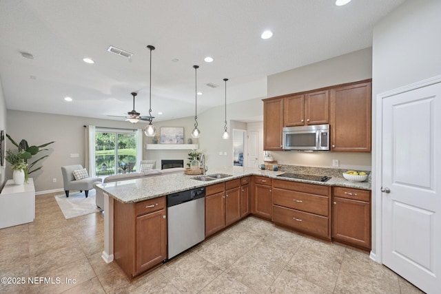 1804 Eagle Crest Dr, Fleming Island, FL 32003 - kitchen featuring stainless steel appliances, brown cabinetry, a peninsula, open floor plan, and recessed lighting