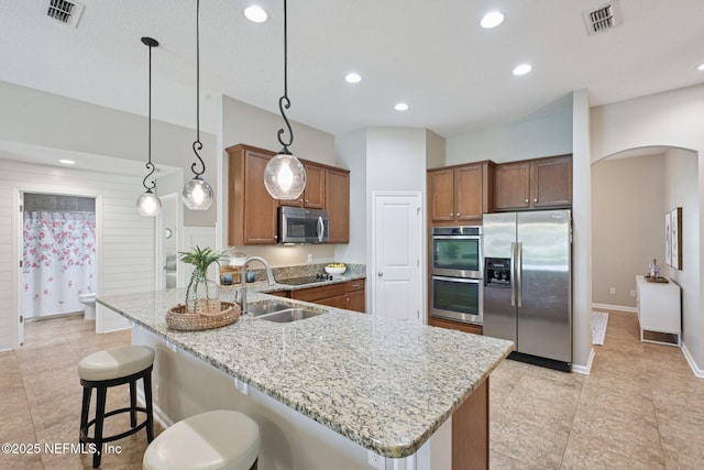 1804 Eagle Crest Dr, Fleming Island, FL 32003 - kitchen featuring stainless steel appliances, arched walkways, a peninsula, light stone counters, and a breakfast bar area