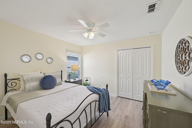 1804 Eagle Crest Dr, Fleming Island, FL 32003 - bedroom with light wood-type flooring, a closet, a textured ceiling, and a ceiling fan