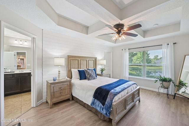 1804 Eagle Crest Dr, Fleming Island, FL 32003 - bedroom with light wood-type flooring, coffered ceiling, connected bathroom, ceiling fan, and beam ceiling