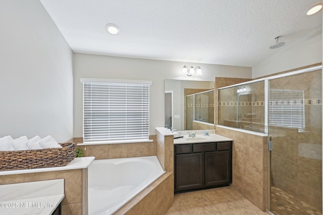 1804 Eagle Crest Dr, Fleming Island, FL 32003 - bathroom with a stall shower, vanity, a garden tub, and a textured ceiling