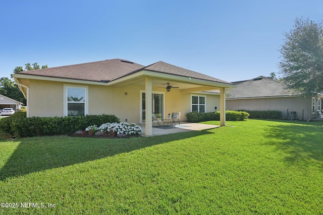 1804 Eagle Crest Dr, Fleming Island, FL 32003 - back of property featuring ceiling fan, a patio area, a lawn, and stucco siding