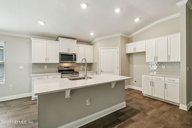 1382 Parkland Trl, Saint Augustine, FL 32095 - kitchen with stainless steel appliances, a sink, crown molding, white cabinets, and recessed lighting