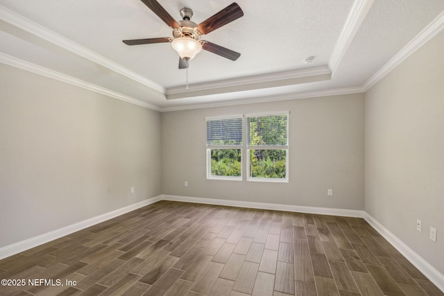 1382 Parkland Trl, Saint Augustine, FL 32095 - unfurnished room featuring a raised ceiling, dark wood finished floors, a ceiling fan, crown molding, and baseboards
