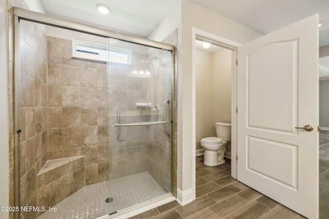 1382 Parkland Trl, Saint Augustine, FL 32095 - bathroom with toilet, a shower stall, and wood tiled floors