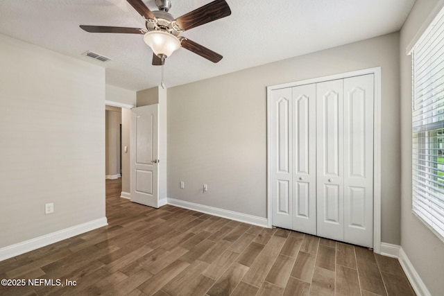 1382 Parkland Trl, Saint Augustine, FL 32095 - unfurnished bedroom featuring wood finished floors, a closet, baseboards, and multiple windows