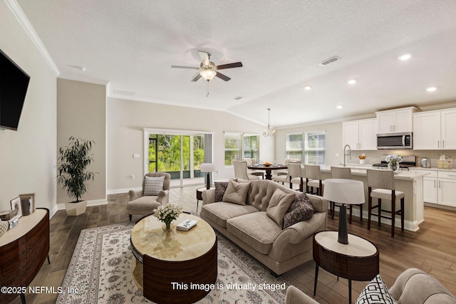 1382 Parkland Trl, Saint Augustine, FL 32095 - living area featuring lofted ceiling, a ceiling fan, light wood-type flooring, ornamental molding, and recessed lighting
