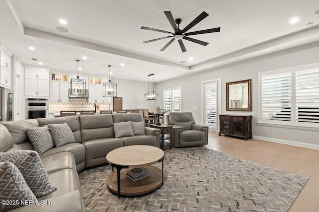87 Tradesman Ln, Saint Johns, FL 32259 - living room with a ceiling fan, light wood-style flooring, recessed lighting, and a chandelier