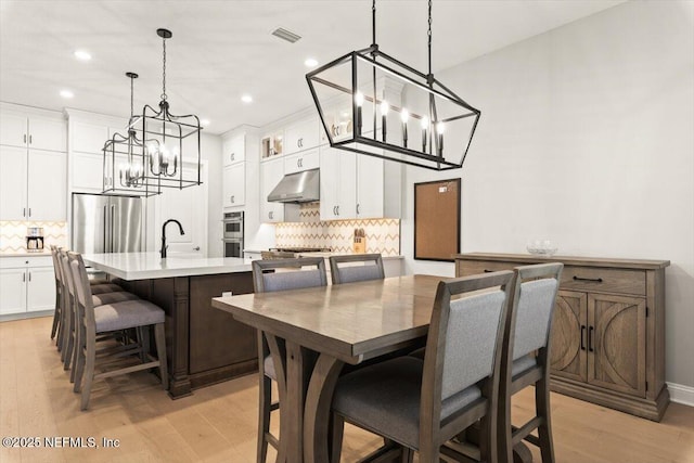87 Tradesman Ln, Saint Johns, FL 32259 - dining area with a chandelier, light wood-style floors, and recessed lighting