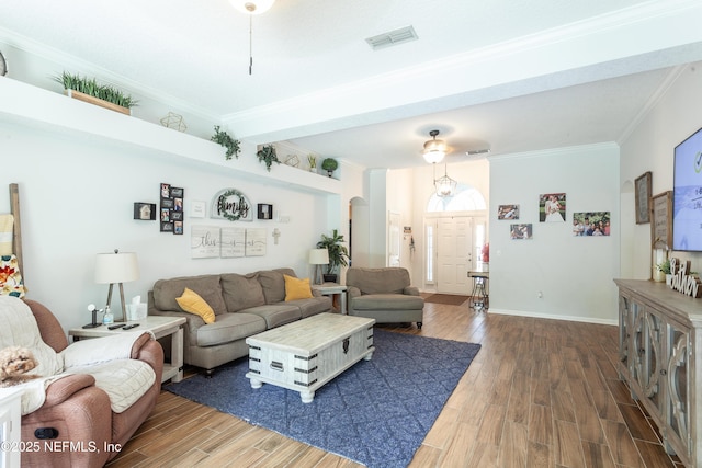 7677 Crosstree Ln, Jacksonville, FL 32256 - living area featuring wood finished floors, crown molding, baseboards, and arched walkways