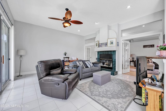6542 Burnham Cir, Ponte Vedra Beach, FL 32082 - living room with french doors, ceiling fan, a fireplace, light tile patterned floors, and baseboards
