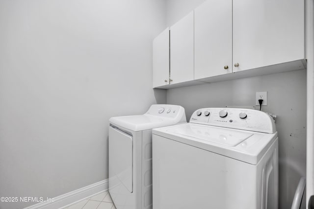 6542 Burnham Cir, Ponte Vedra Beach, FL 32082 - laundry area featuring cabinet space, washer and dryer, baseboards, and light tile patterned floors