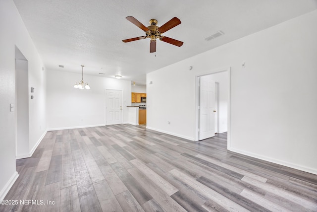 3641 Kirkpatrick Cir Unit 14-2, Jacksonville, FL 32210 - unfurnished living room with a chandelier, ceiling fan, wood finished floors, and baseboards