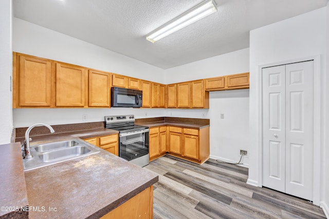 3641 Kirkpatrick Cir Unit 14-2, Jacksonville, FL 32210 - kitchen with black microwave, stainless steel electric range oven, a sink, a textured ceiling, and light wood-type flooring