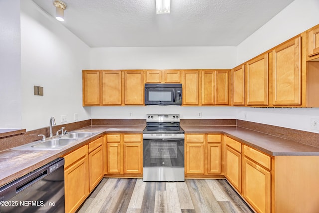 3641 Kirkpatrick Cir Unit 14-2, Jacksonville, FL 32210 - kitchen with black microwave, stainless steel electric range oven, dishwasher, a sink, and light wood-style floors