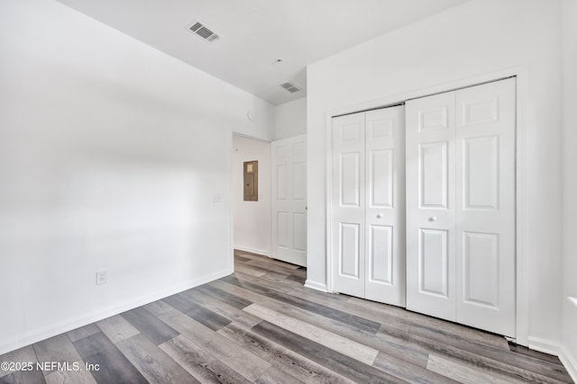 3641 Kirkpatrick Cir Unit 14-2, Jacksonville, FL 32210 - unfurnished bedroom featuring electric panel, a closet, and wood finished floors