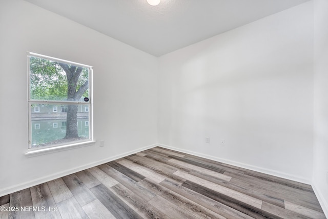 3641 Kirkpatrick Cir Unit 14-2, Jacksonville, FL 32210 - spare room featuring wood finished floors and baseboards