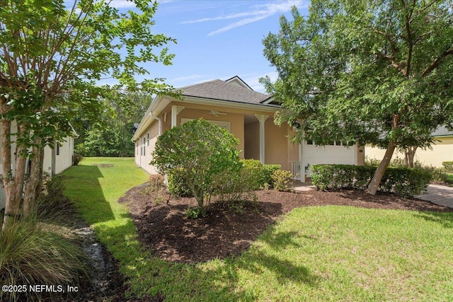 1327 Castle Pines Cir, Saint Augustine, FL 32092 - view of property exterior with stucco siding, a yard, and a garage