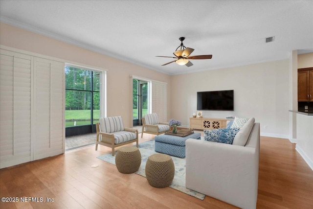 1327 Castle Pines Cir, Saint Augustine, FL 32092 - living room featuring wood finished floors, a ceiling fan, and crown molding