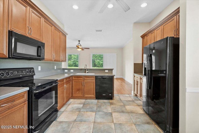 1327 Castle Pines Cir, Saint Augustine, FL 32092 - kitchen with black appliances, a ceiling fan, a peninsula, brown cabinets, and light countertops