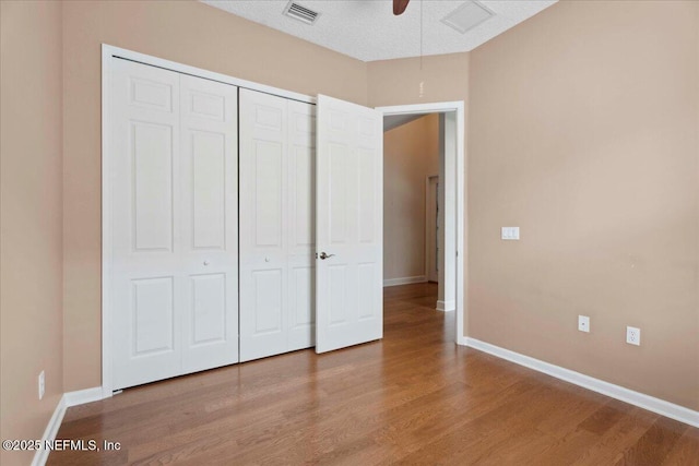 1327 Castle Pines Cir, Saint Augustine, FL 32092 - unfurnished bedroom with wood finished floors, a closet, and ceiling fan