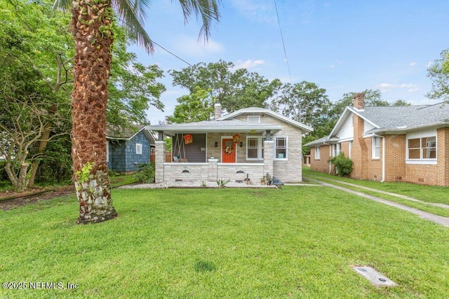 1032 Ingleside Ave, Jacksonville, FL 32205 - bungalow-style house featuring a porch, a front yard, stone siding, and a chimney