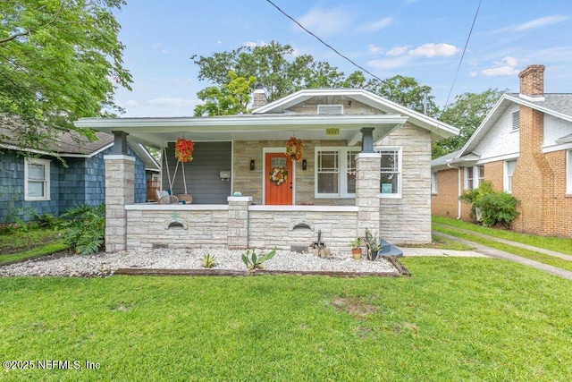 1032 Ingleside Ave, Jacksonville, FL 32205 - view of front of property featuring stone siding, covered porch, and a front yard