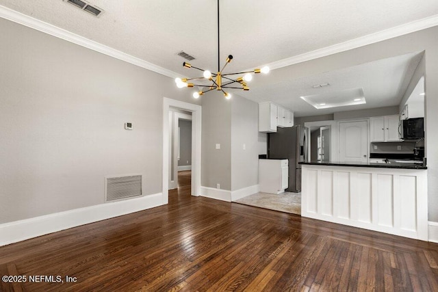 1032 Ingleside Ave, Jacksonville, FL 32205 - kitchen with stainless steel refrigerator with ice dispenser, a chandelier, hardwood / wood-style floors, dark countertops, and ornamental molding