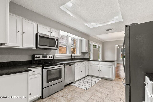 1032 Ingleside Ave, Jacksonville, FL 32205 - kitchen featuring stainless steel appliances, white cabinets, crown molding, recessed lighting, and a textured ceiling
