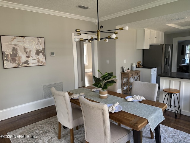 1032 Ingleside Ave, Jacksonville, FL 32205 - dining area featuring wood finished floors, a chandelier, a textured ceiling, and ornamental molding