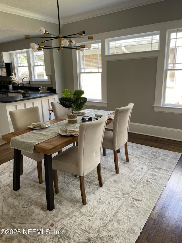 1032 Ingleside Ave, Jacksonville, FL 32205 - dining area with a chandelier, ornamental molding, healthy amount of natural light, wood finished floors, and a textured ceiling