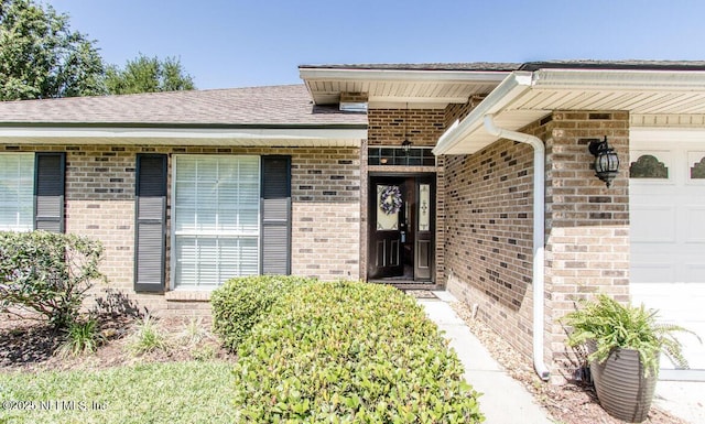 2002 Knottingham Trace Ln, Jacksonville, FL 32246 - property entrance with an attached garage and brick siding