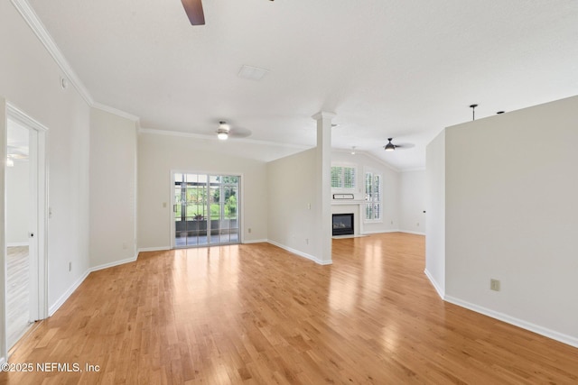 2002 Knottingham Trace Ln, Jacksonville, FL 32246 - unfurnished living room with a ceiling fan, vaulted ceiling, light wood-type flooring, a glass covered fireplace, and ornamental molding