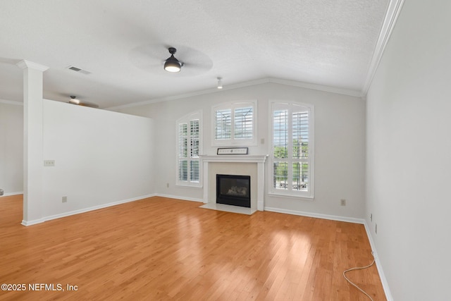 2002 Knottingham Trace Ln, Jacksonville, FL 32246 - unfurnished living room featuring crown molding, a ceiling fan, light wood-style flooring, lofted ceiling, and a fireplace with flush hearth