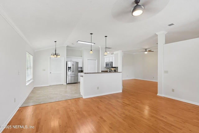 2002 Knottingham Trace Ln, Jacksonville, FL 32246 - kitchen with appliances with stainless steel finishes, ceiling fan, open floor plan, white cabinetry, and light wood-style flooring