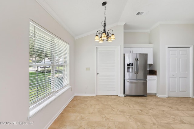 2002 Knottingham Trace Ln, Jacksonville, FL 32246 - kitchen with stainless steel fridge with ice dispenser, plenty of natural light, a chandelier, crown molding, and white cabinetry
