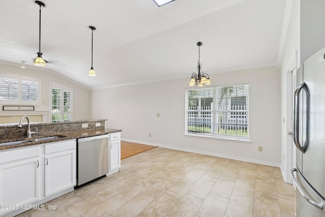 2002 Knottingham Trace Ln, Jacksonville, FL 32246 - kitchen featuring stainless steel appliances, ornamental molding, pendant lighting, white cabinets, and dark stone counters