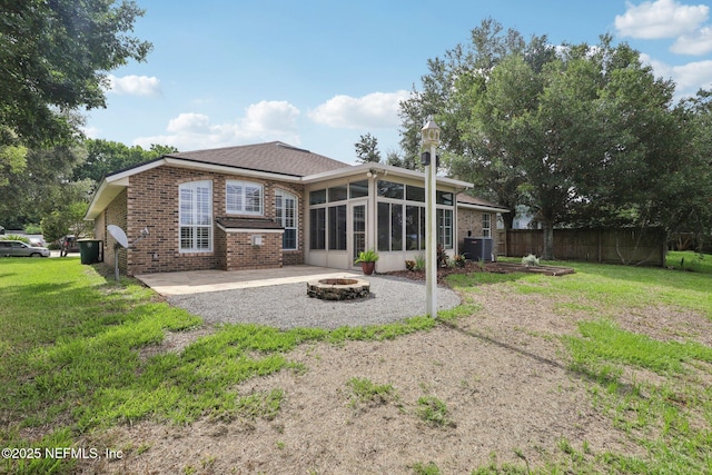 2002 Knottingham Trace Ln, Jacksonville, FL 32246 - rear view of house with an outdoor fire pit, a sunroom, brick siding, and a patio