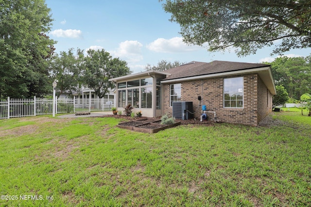 2002 Knottingham Trace Ln, Jacksonville, FL 32246 - rear view of property with a sunroom, brick siding, a shingled roof, and a garden