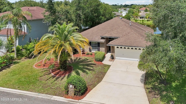 2002 Knottingham Trace Ln, Jacksonville, FL 32246 - view of front of property with an attached garage, concrete driveway, a front yard, and roof with shingles