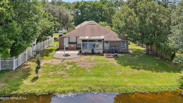 2002 Knottingham Trace Ln, Jacksonville, FL 32246 - rear view of house with brick siding, a fenced backyard, a water view, and a patio area