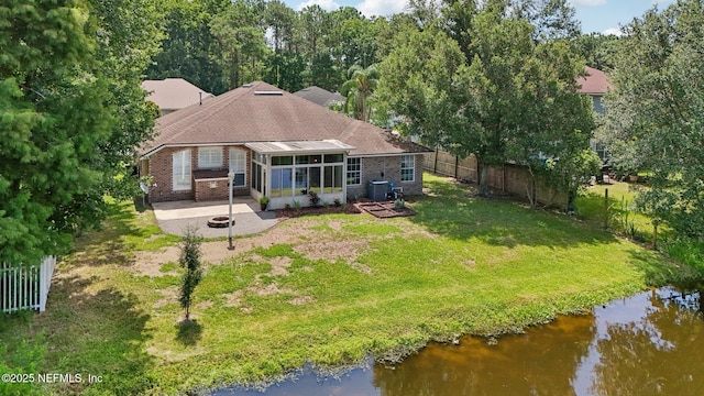 2002 Knottingham Trace Ln, Jacksonville, FL 32246 - rear view of property with a sunroom, an outdoor fire pit, a fenced backyard, brick siding, and a patio area