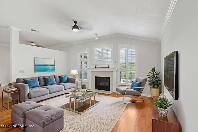 2002 Knottingham Trace Ln, Jacksonville, FL 32246 - living room featuring crown molding, wood finished floors, lofted ceiling, a fireplace with flush hearth, and a ceiling fan