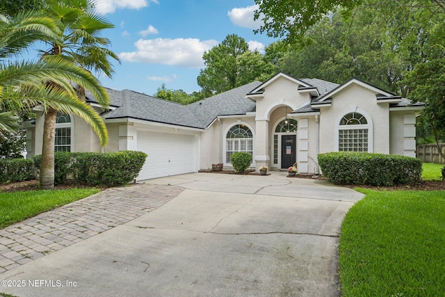 1867 Willesdon Dr E, Jacksonville, FL 32246 - view of front of property with stucco siding, concrete driveway, a garage, and roof with shingles