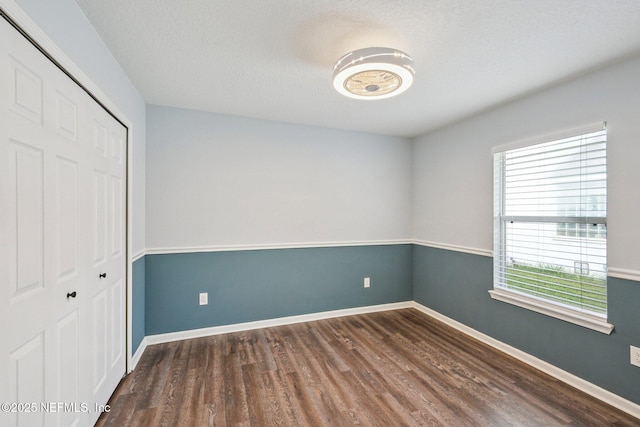 1867 Willesdon Dr E, Jacksonville, FL 32246 - unfurnished bedroom with wood finished floors, a closet, and a textured ceiling